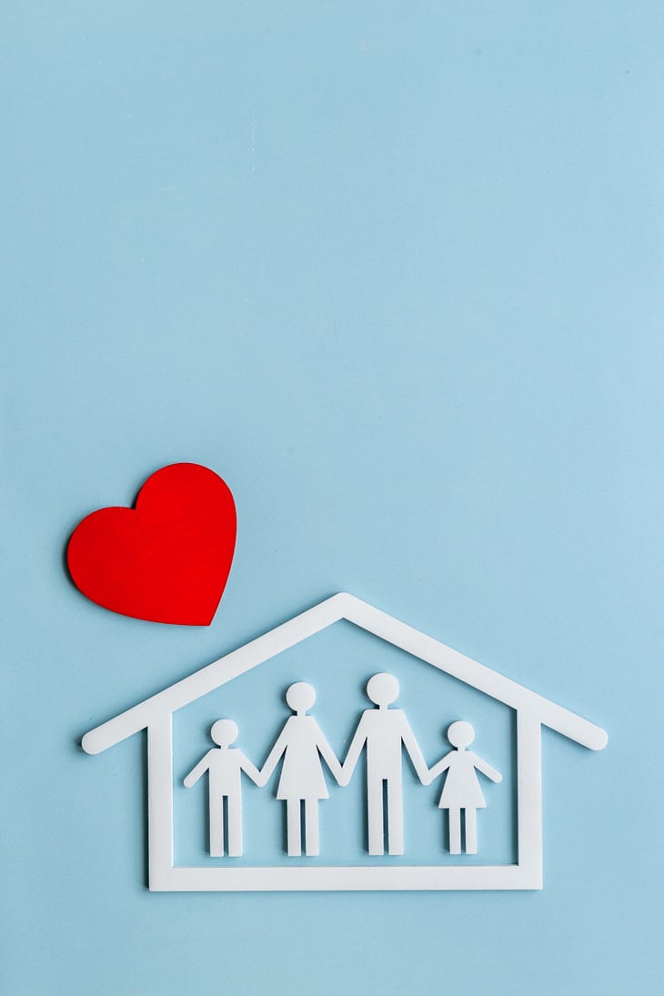 Family figure in wooden house with heart shape. Happy family, protection concept